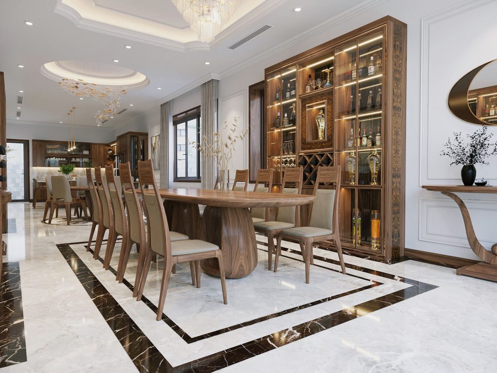 Thiết kế nội thất phòng ăn vương giả với bộ bàn ghế gỗ óc chó tinh xảo và hệ tủ rượu cánh kính sang trọng.